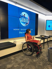 Woman sitting in a wheelchair presenting and talking