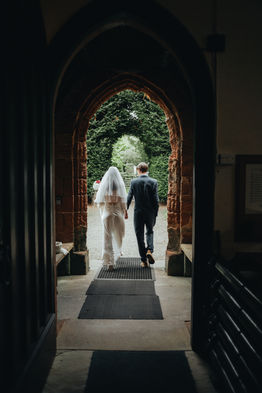 bride and groom candid walking out of church 