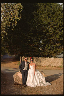 Couple sat on rock at golden hour Worton Hall Oxfordshire