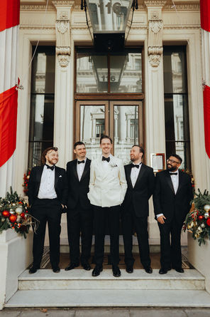 The groomsmen standing confidently outside 116 Pall Mall, captured in a stylish and relaxed group pose.