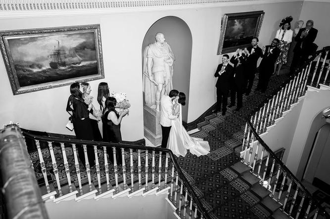 first kiss for husband and wife on stairs at 116 Pall Mall London
