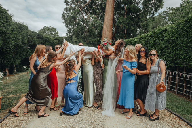 bridals party lifting bride in the air back garden wedding UK 