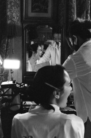 film image of bride laughing in mirror