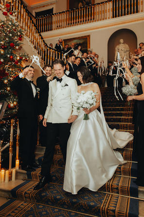 bride and groom laughing walking down stairs at 116 Pall Mall London