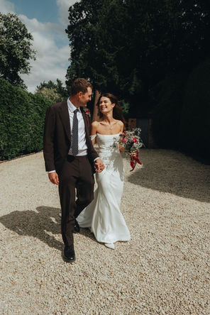 bride smiling at groom during a walk back yard uk 