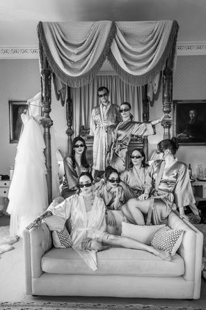 bridal party posing on four post bed at Carlton Towers