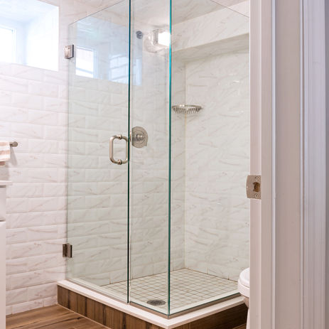 With wood grain style floor tile and classic subway tile walls this bath makes an impact
