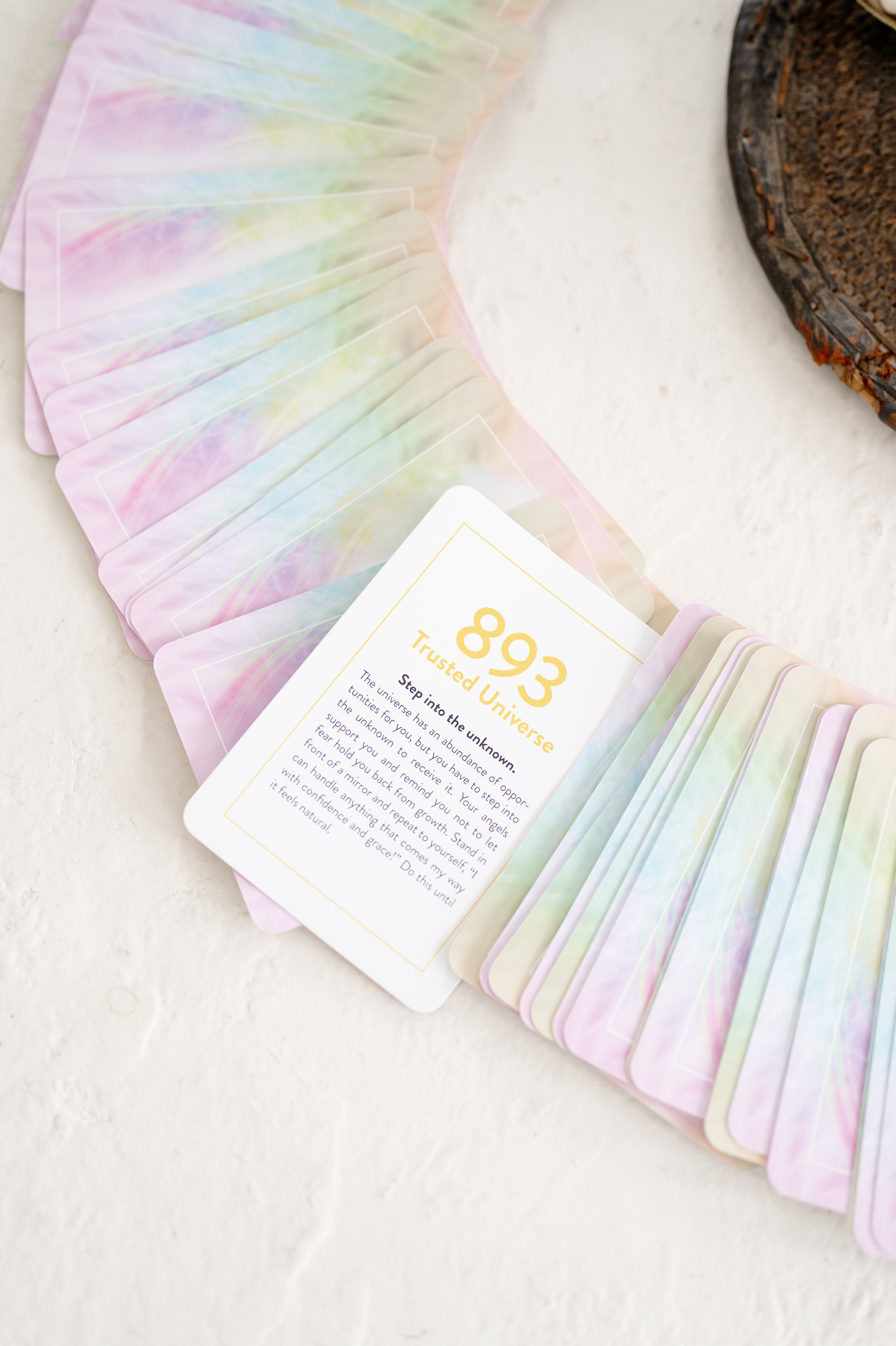 Fanned pastel cards, one showing '893' and text