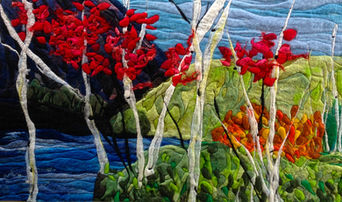 Handcrafted felted fibre landscape of vivid red trees by the water, layered with greens and blues, Canadian textile artwork by Lindsey Mctavish