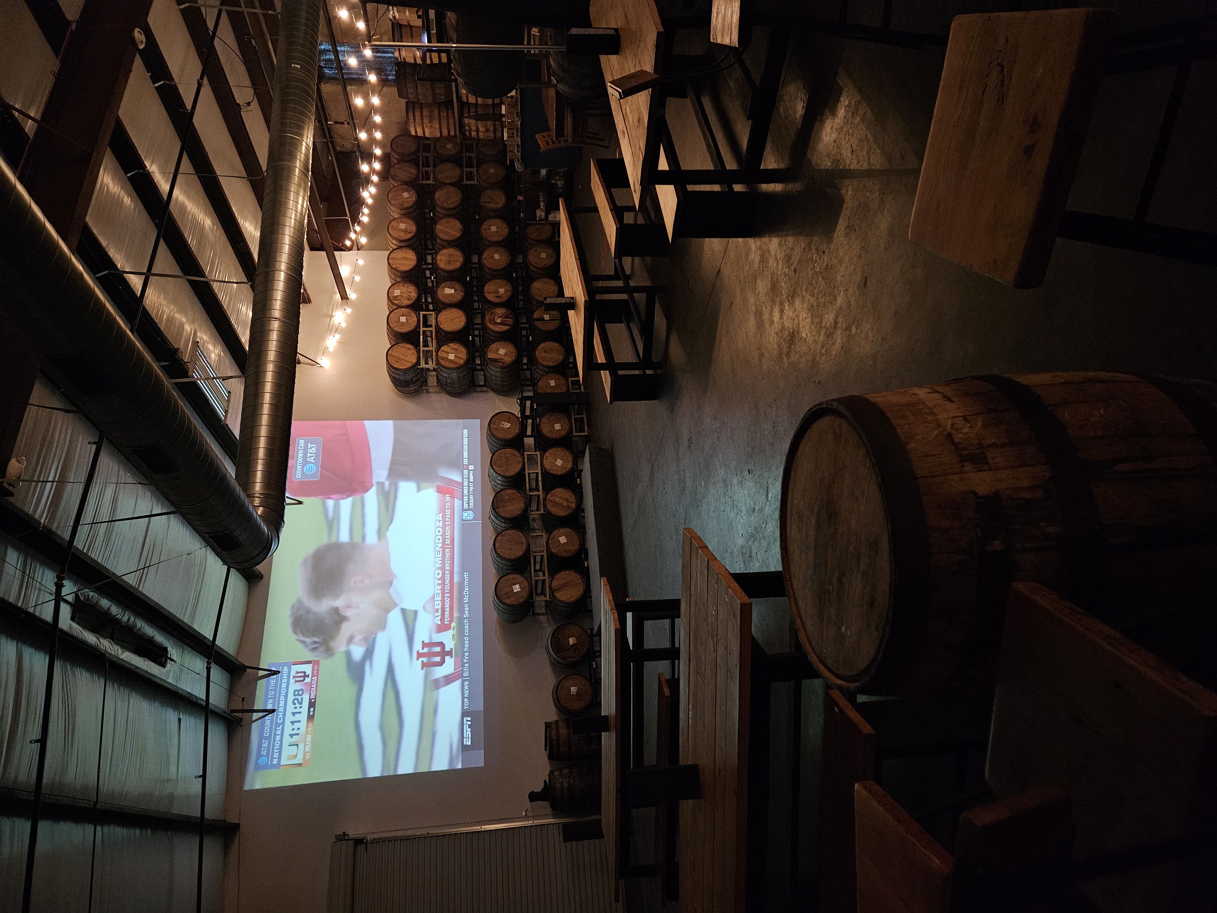Dark projector room inside William Price Distilling set up for Houston World Cup watch parties.