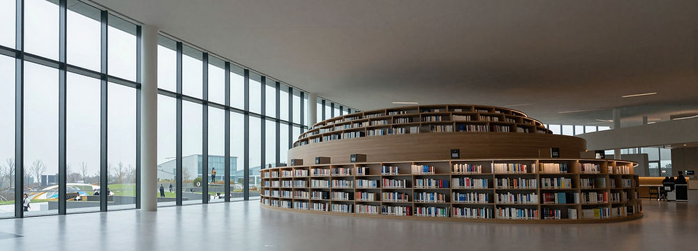 Modern library with a circular bookshelf and large windows