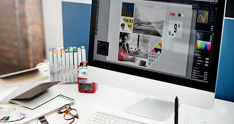 Graphic designer workspace with computer and creative tools