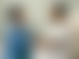 CRNA counsels slightly smiling patient in preoperative holding area