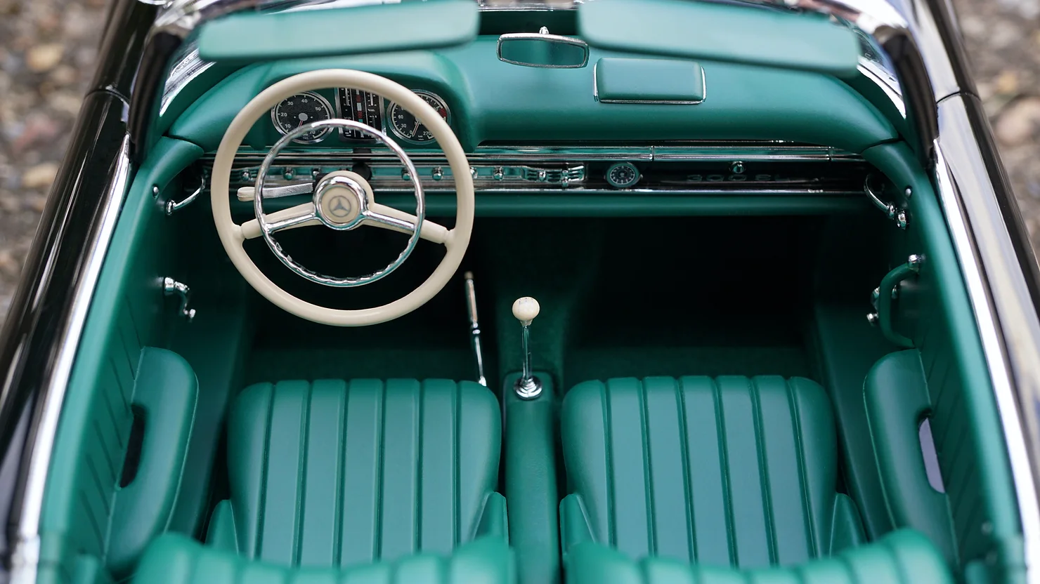 Baby blue vintage with no roof and white stearing wheel