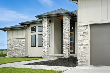 Front exterior view of a luxury home showcasing elegant architecture and curb appeal by Empire Estates.