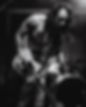 Man playing guitar onstage, black and white photo of musician performing.