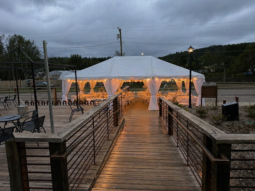 Lighted white tent event set up for a wedding