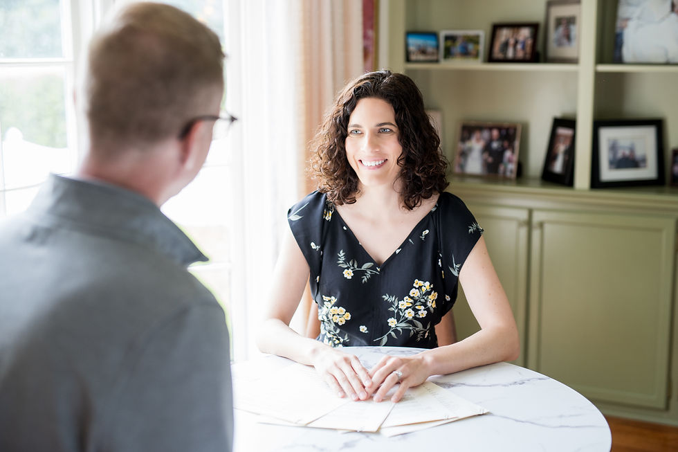 Woman (Kendra Hampton) smiling and talking to a male client in a table