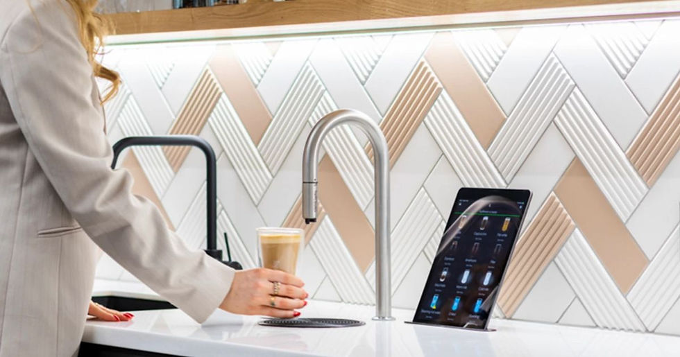 A hand holding a cup of coffee filled from an automatic coffee dispenser