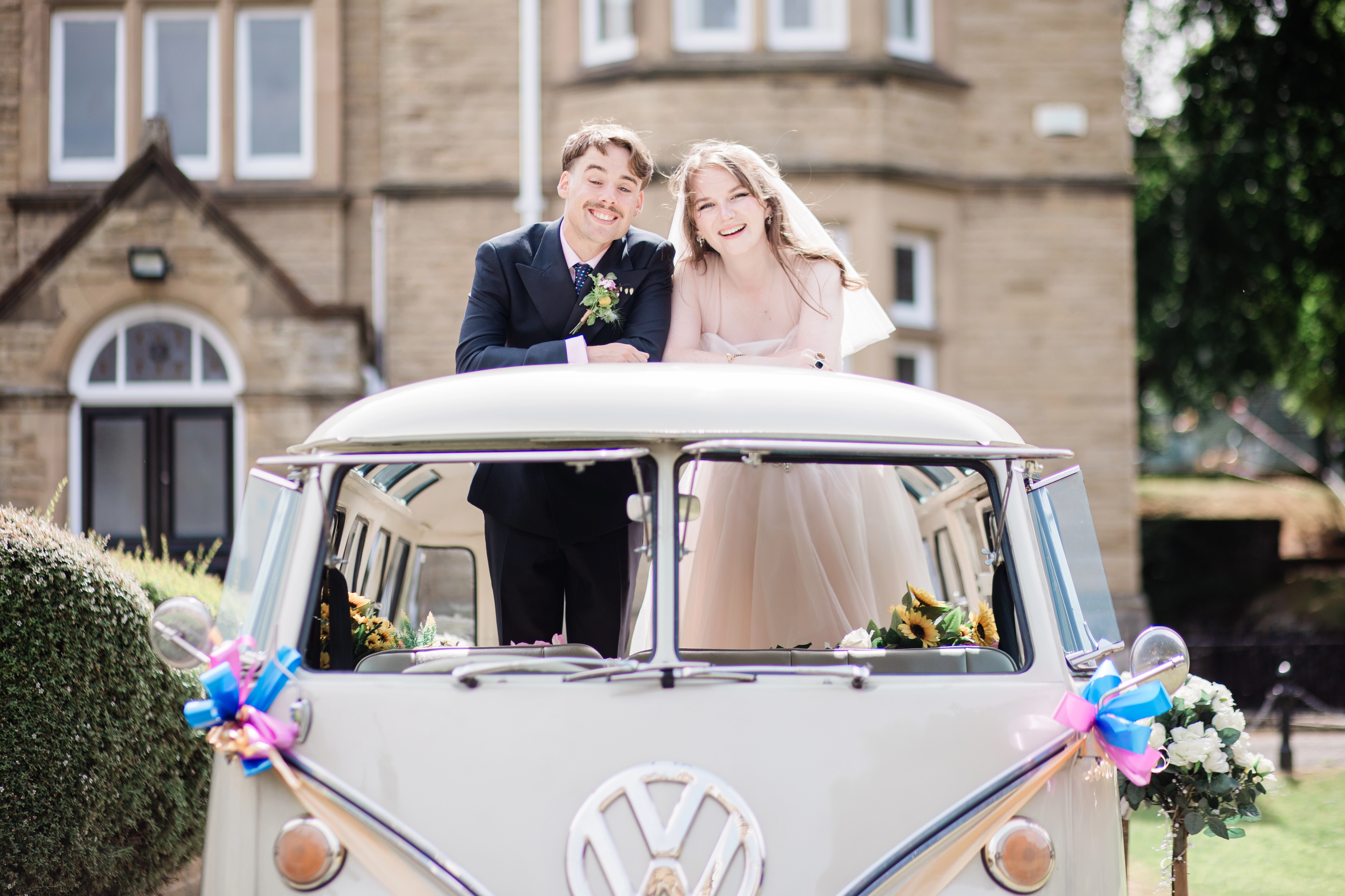 The bride and groom stood out the top of the VW Camper