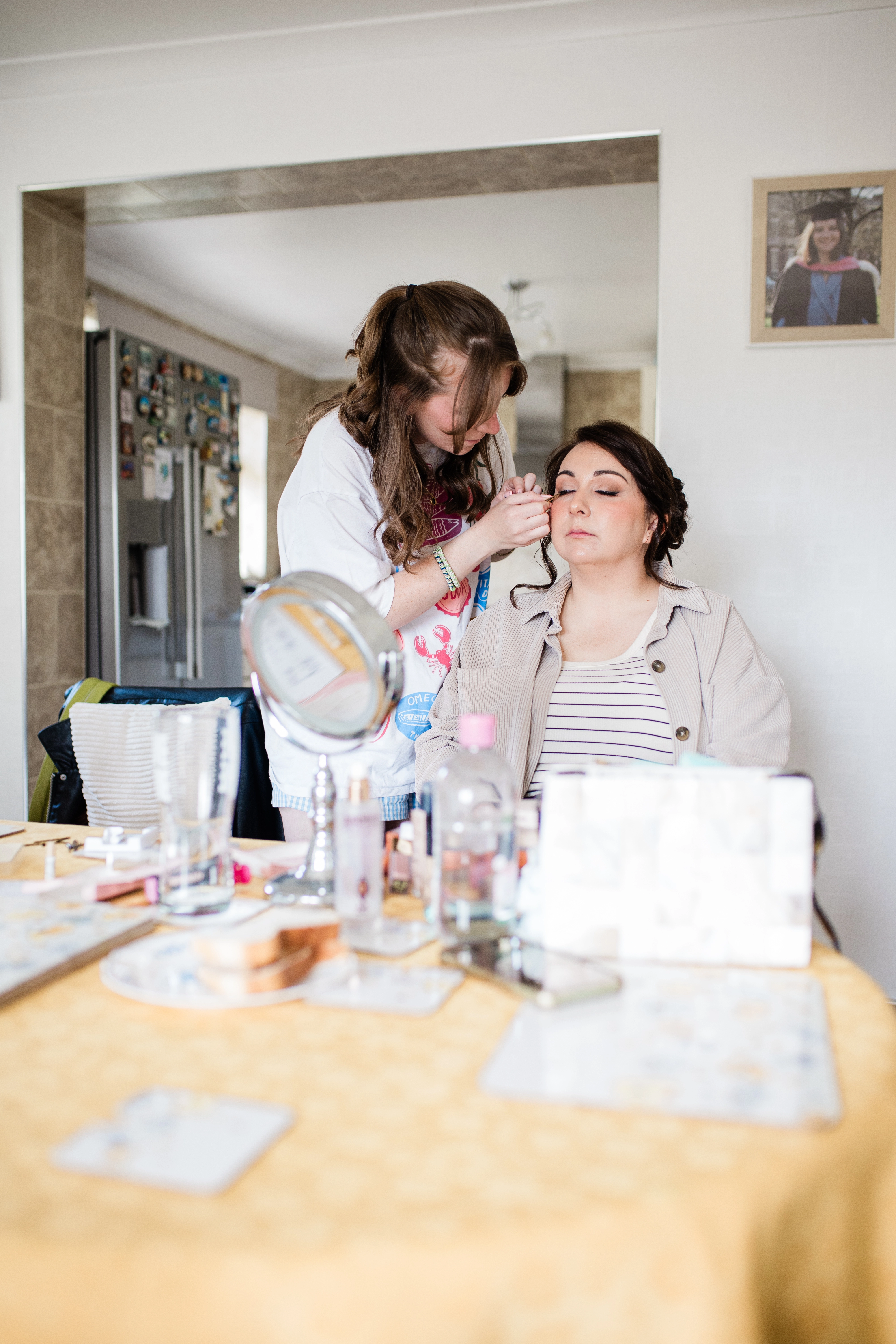 Bride doing one of the bridal party's makeup