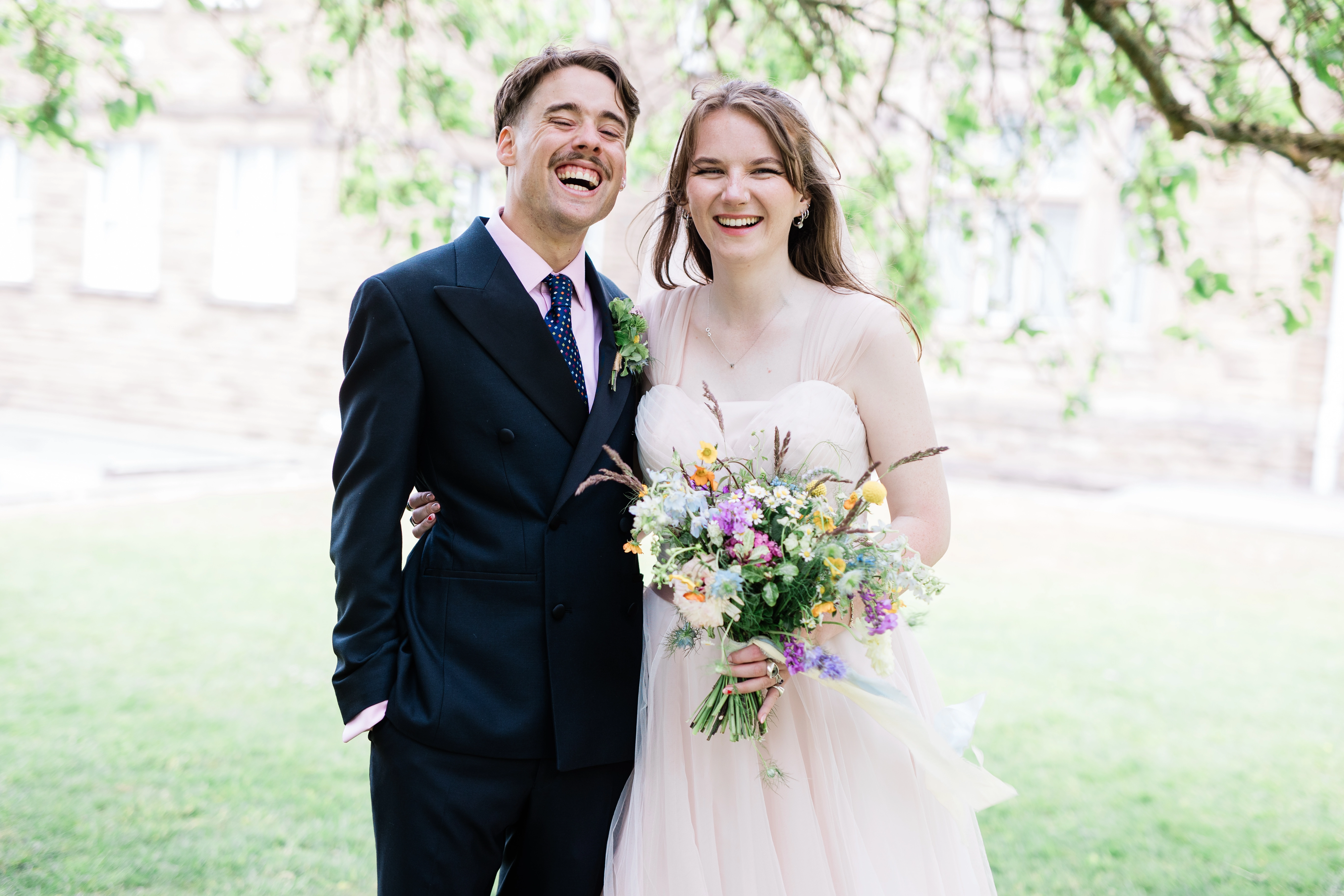 The bride and groom laughing