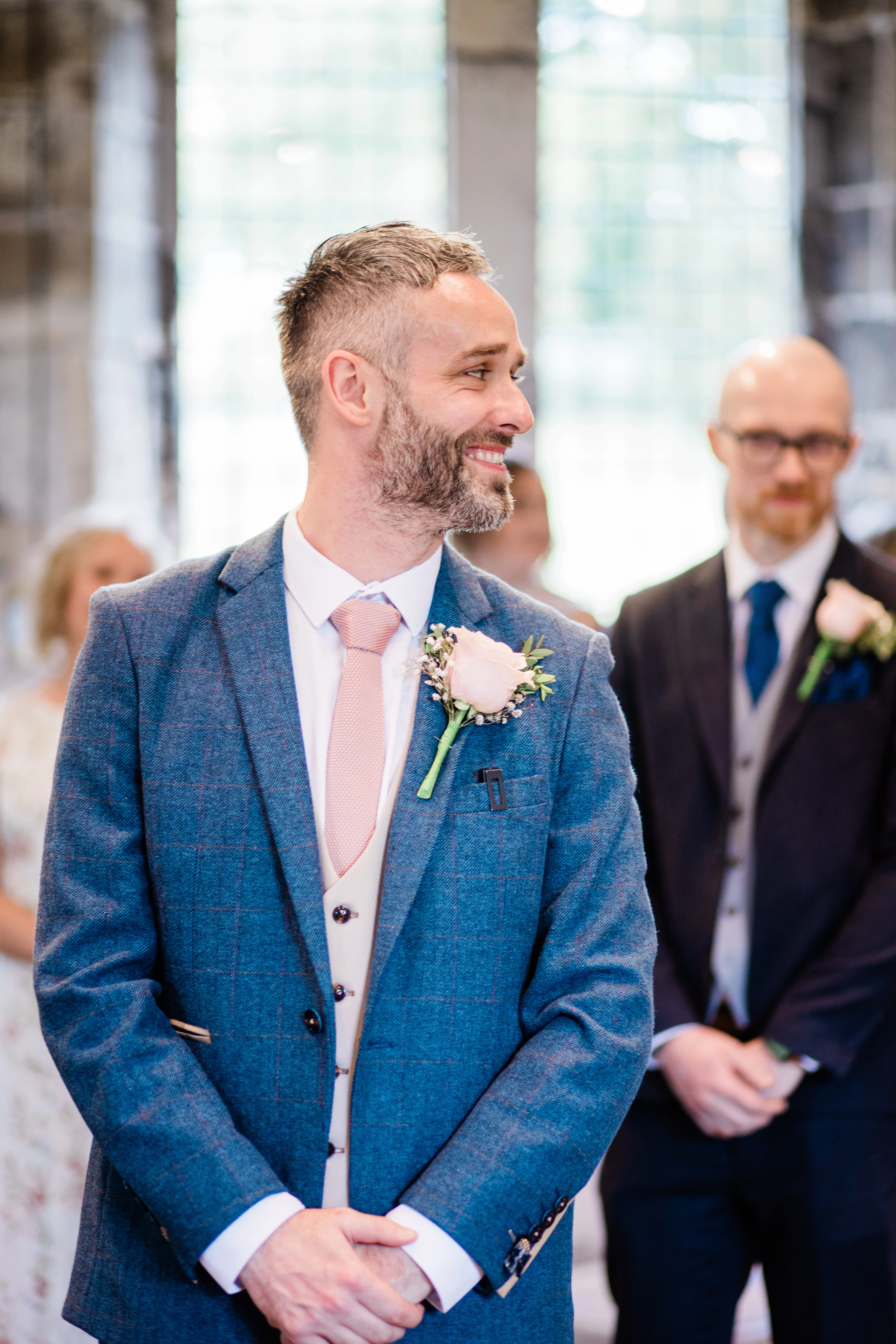 the groom seeing the bride for the first time at the end of the aisle