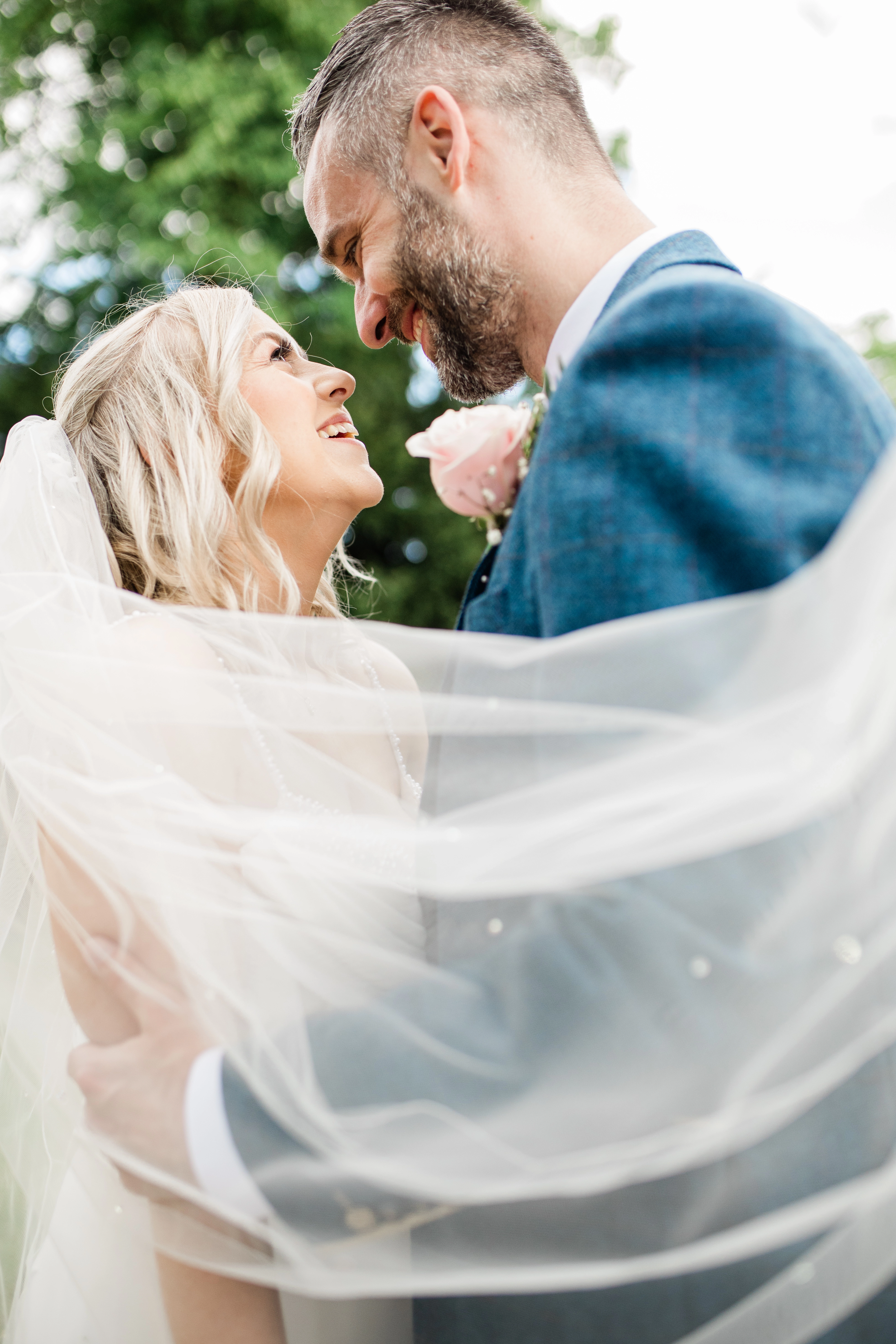 the bride and groom looking at each other lovingly
