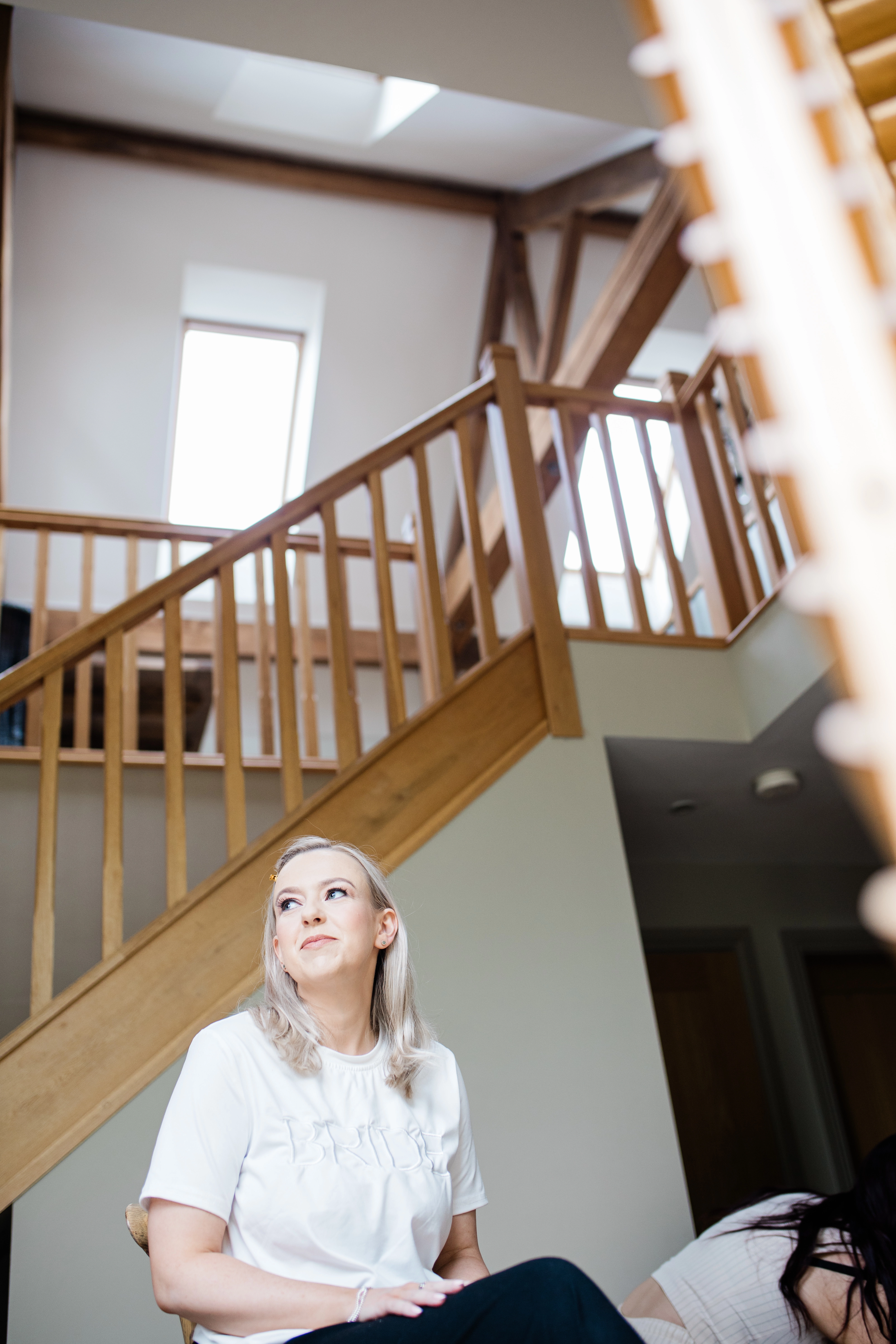 The bride awaiting below the staircase at the bridal prep area