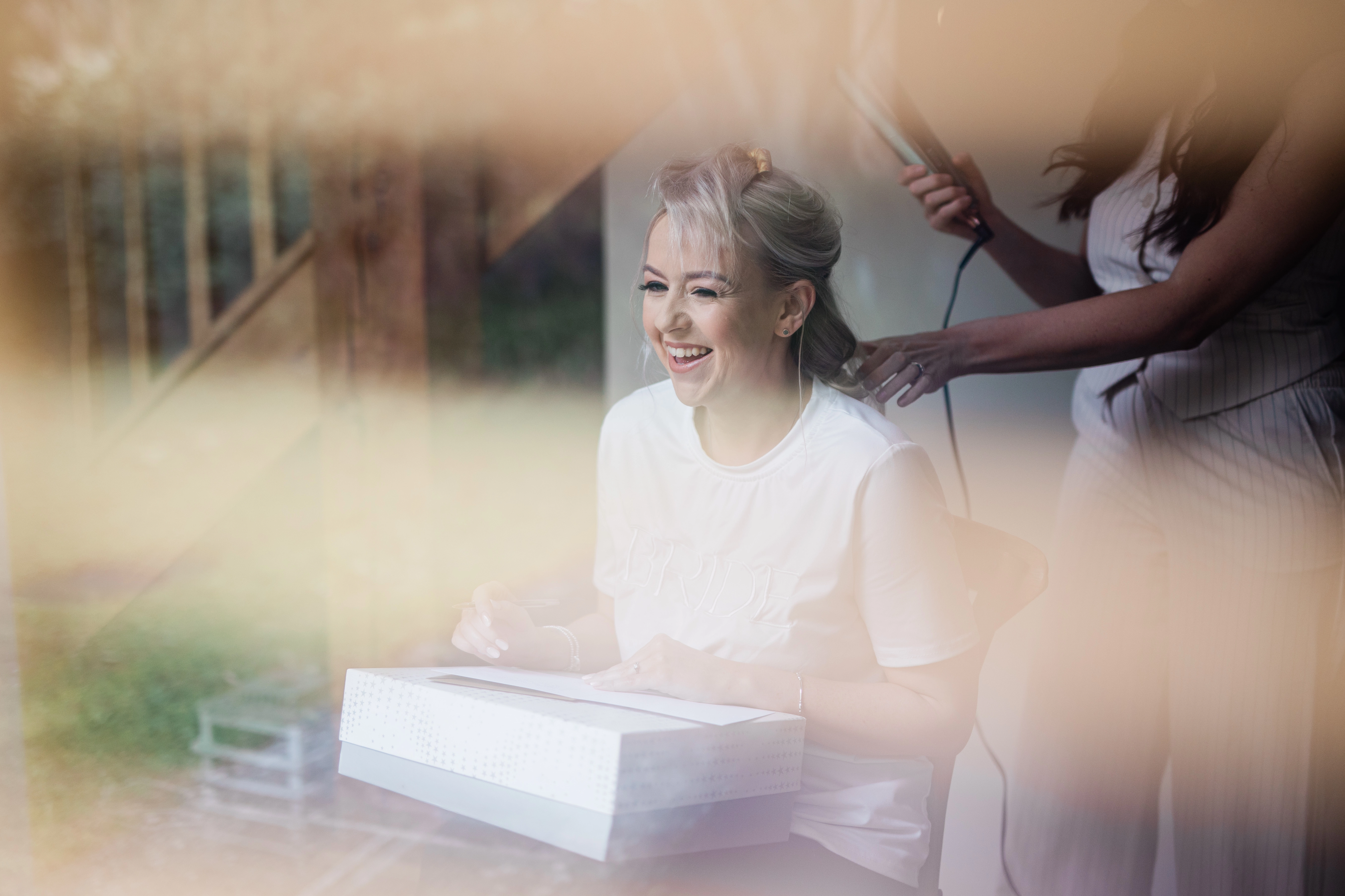 The bride getting her hair done prior to the wedding