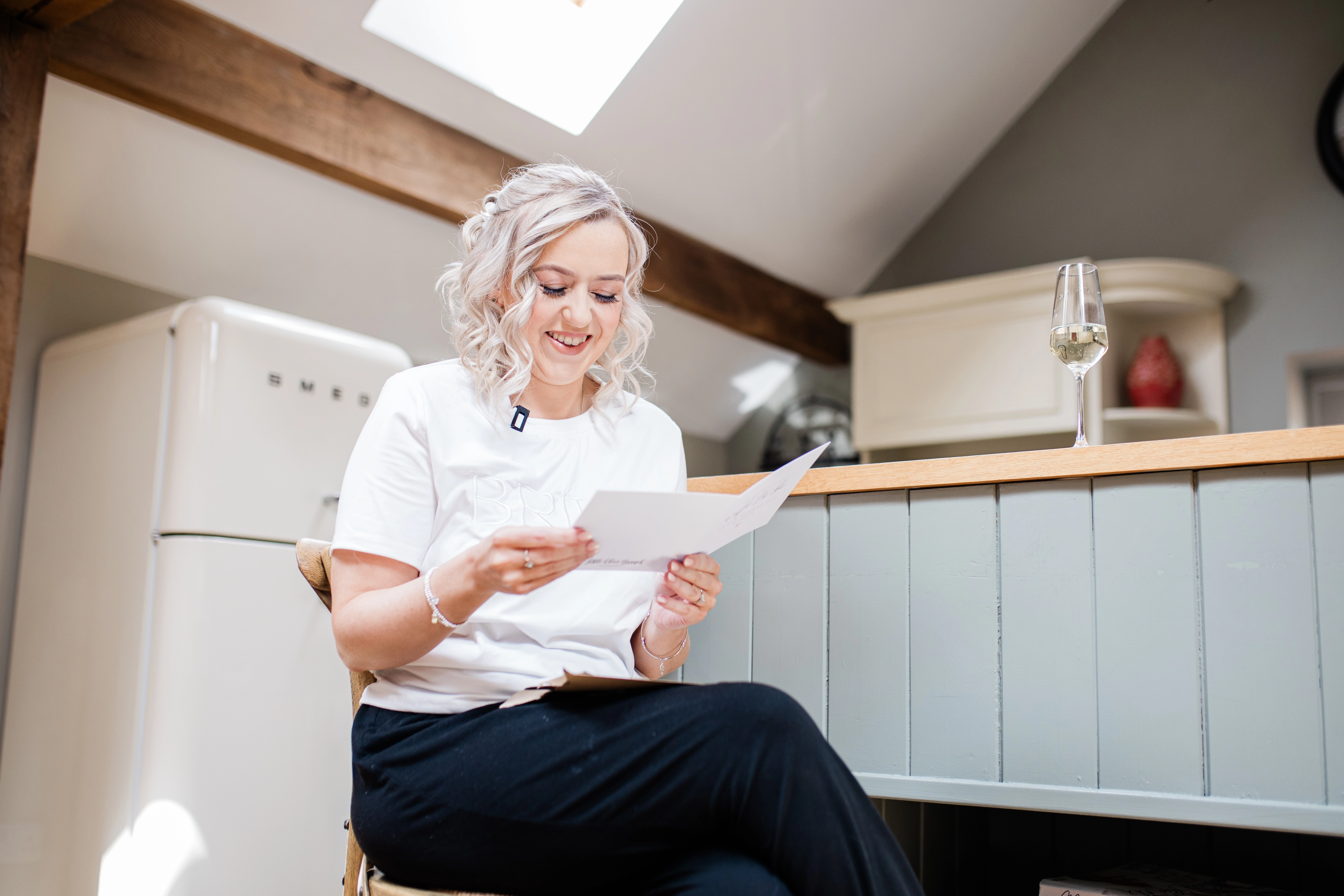 The bride reading the card that has been given to her by the groom