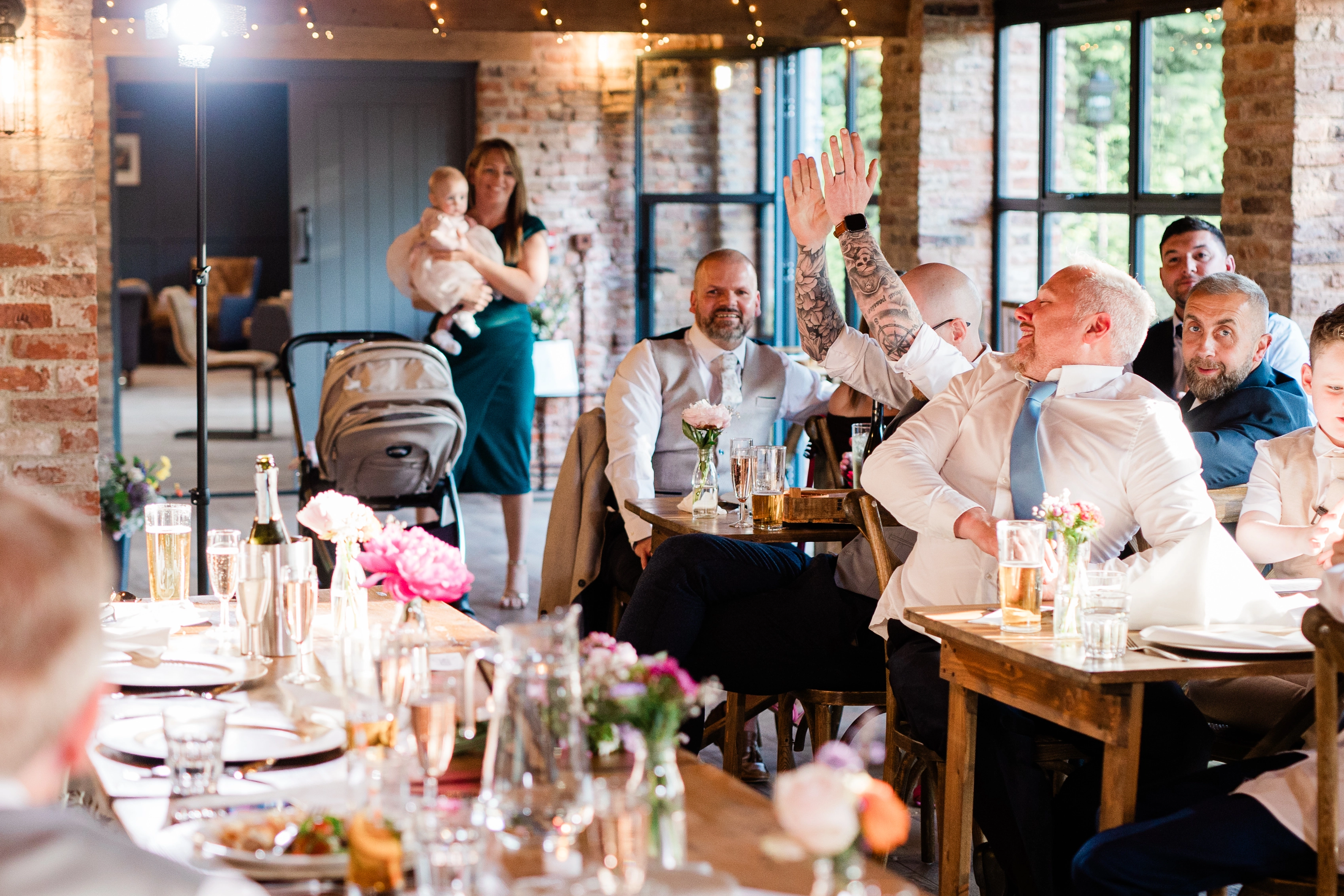 The best man cheering and others onlooking