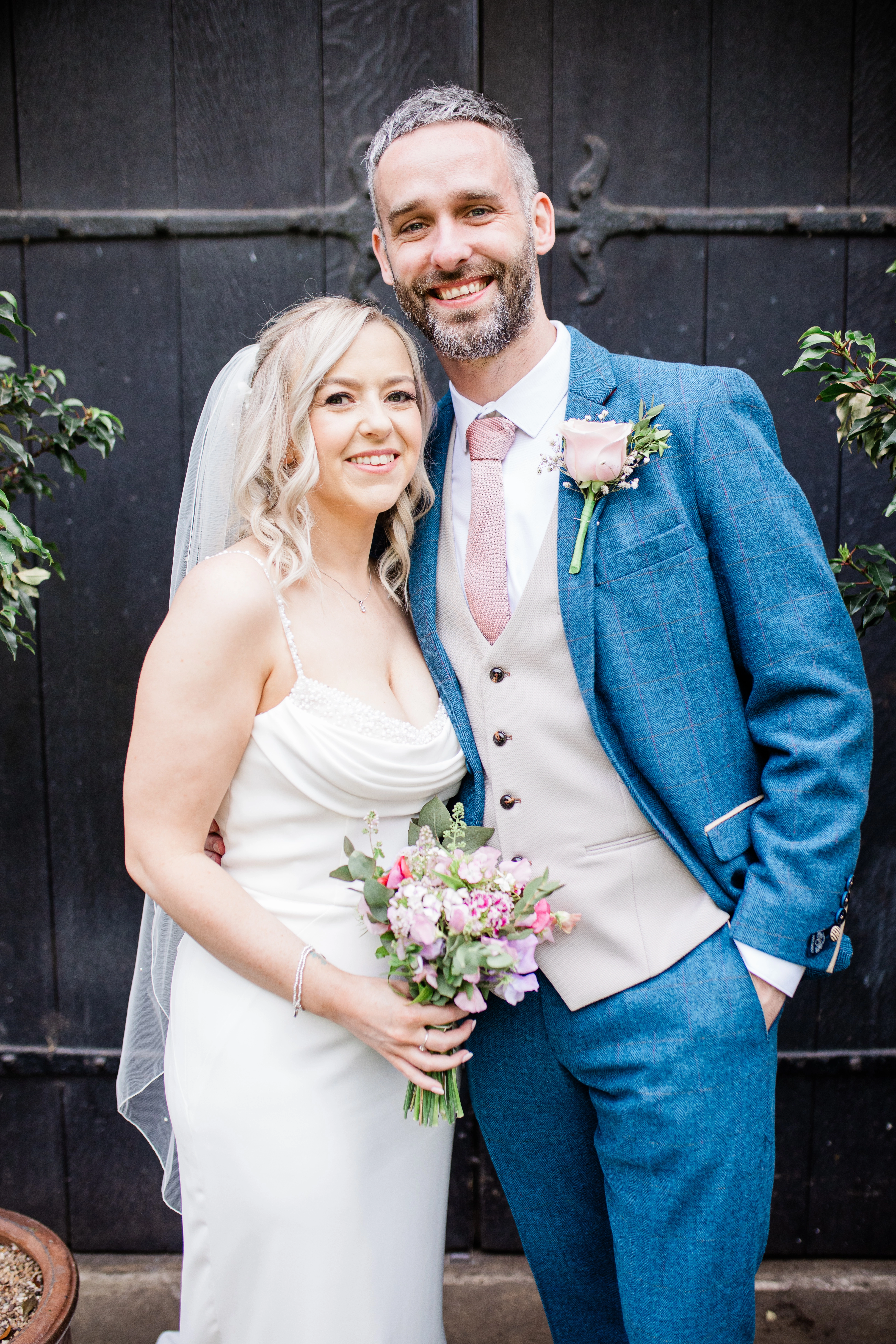 the bride and groom near the front door of the hospitium, York