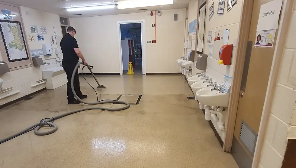 Connar cleaning a school bathroom floor
