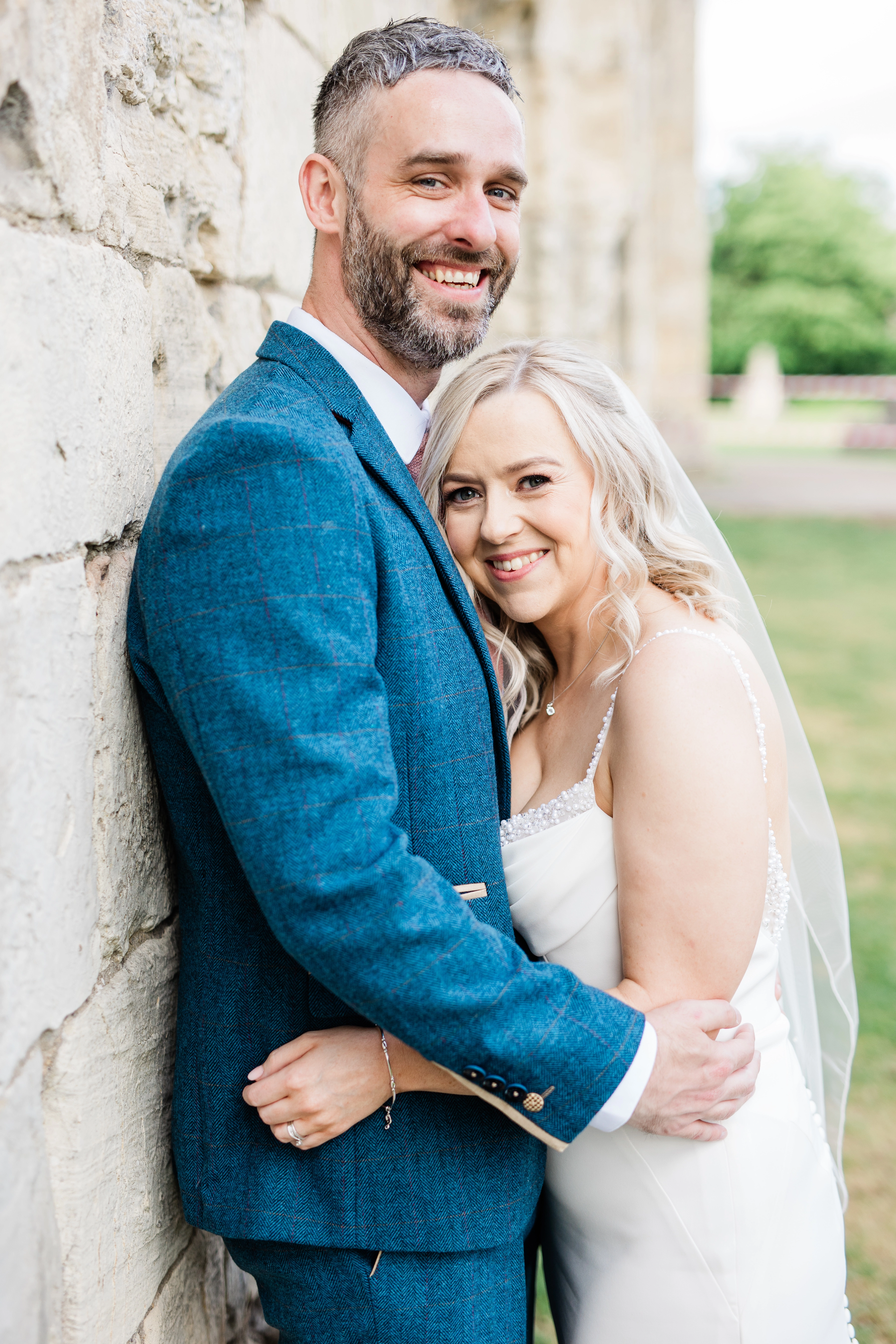 The bride and groom looking at the camera smiling