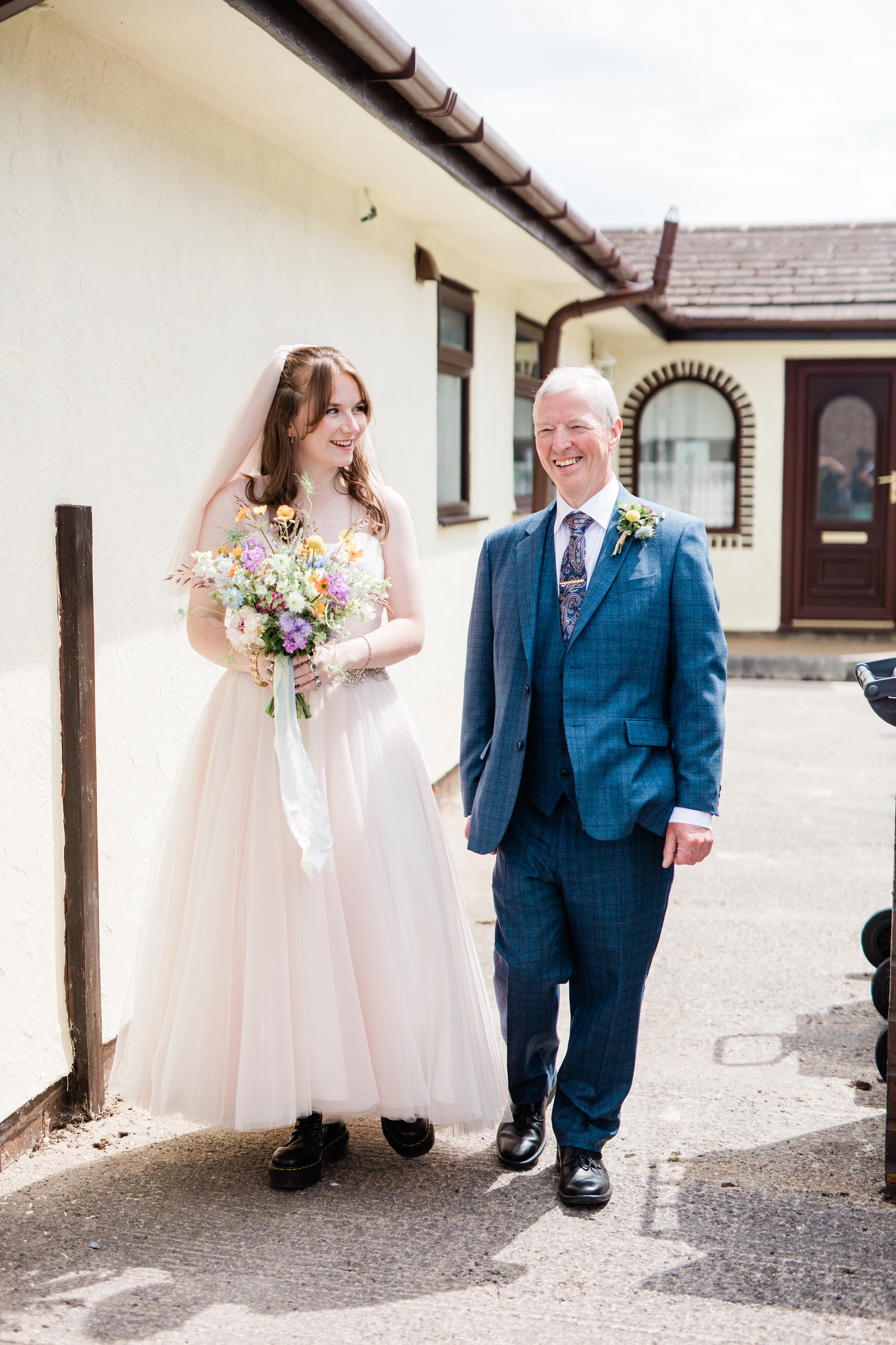 Father of the bride walking her to the wedding transport