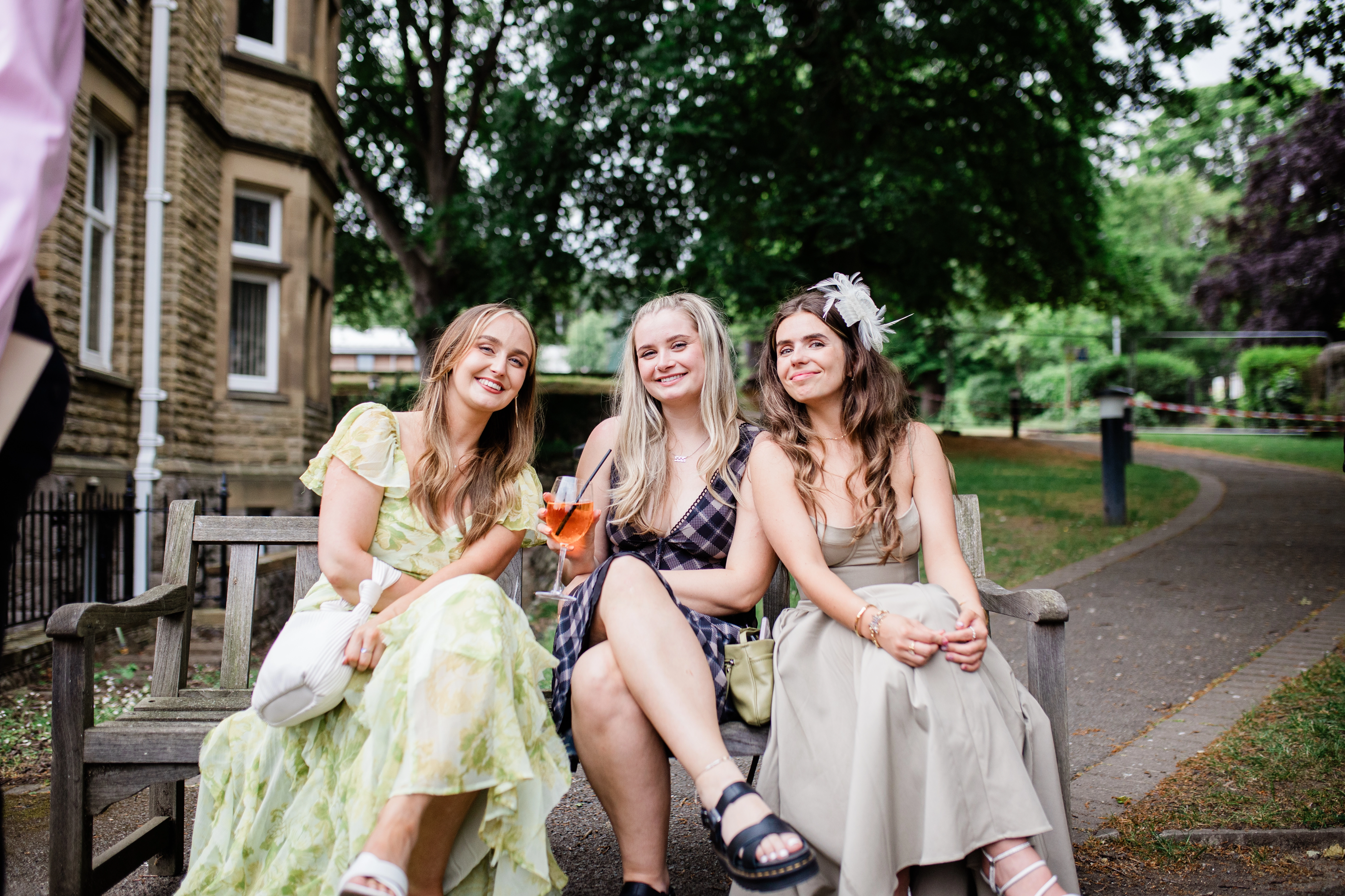 3 guests sat together drinking outside