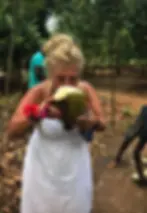 beverley in st lucia drinking from some fruit.webp