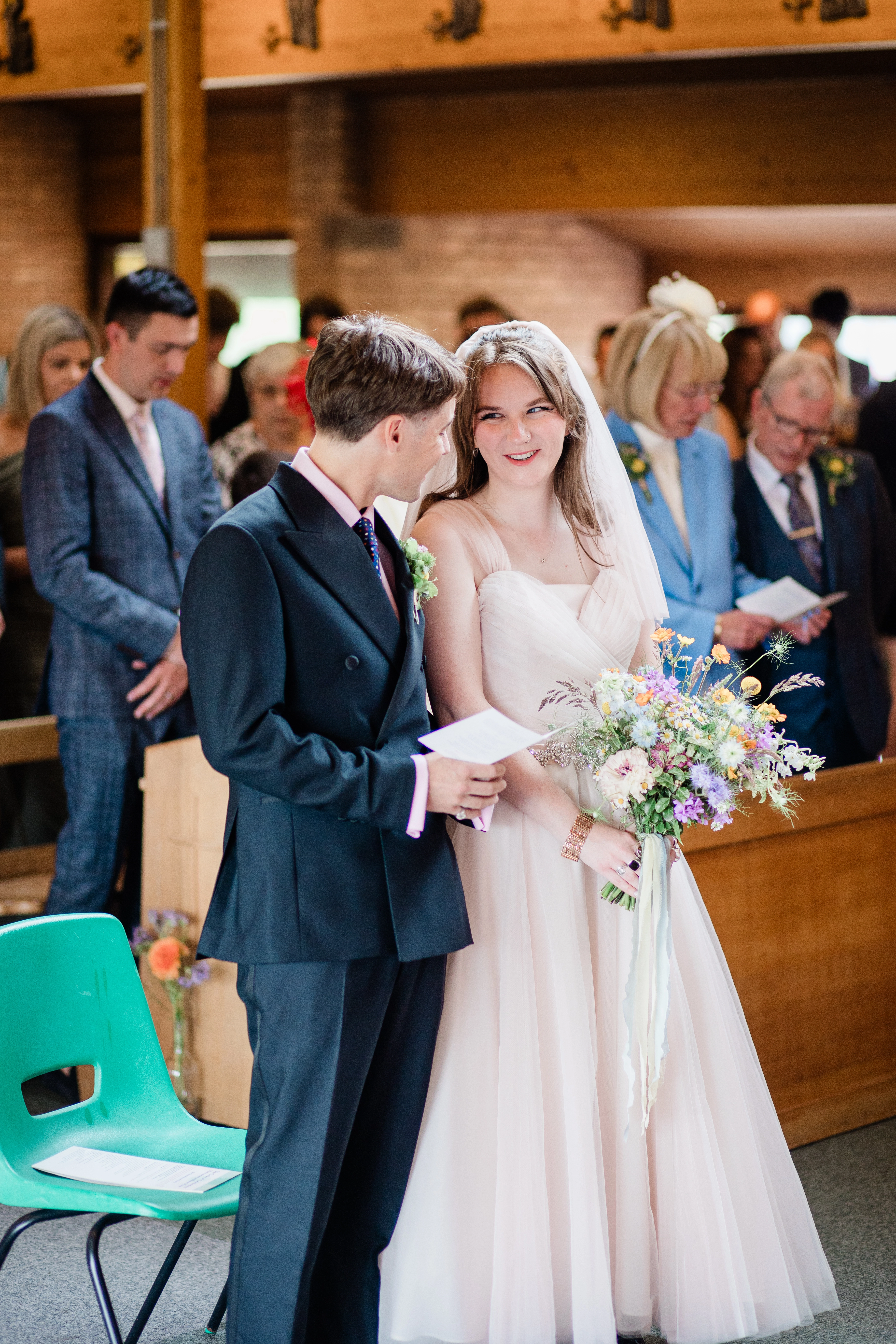 A Bride and Groom meeting at the end of the aisle for the first time