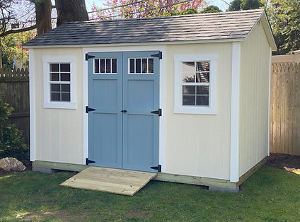 Yellow shed with blue transom window doors