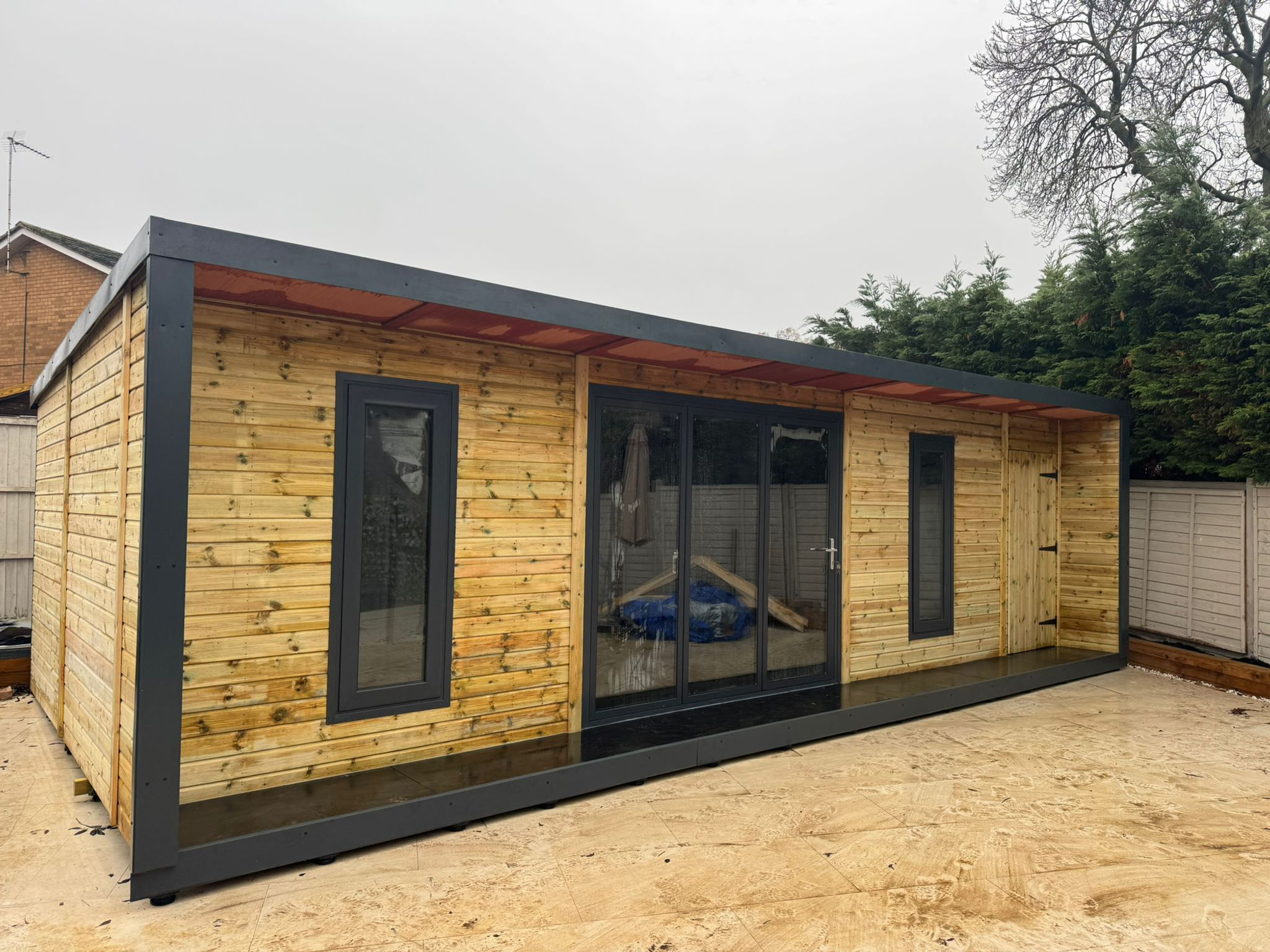28x12 Summerhouse with Bifold doors, 2 Windows, Wooden Shed Door, 2ft Porch