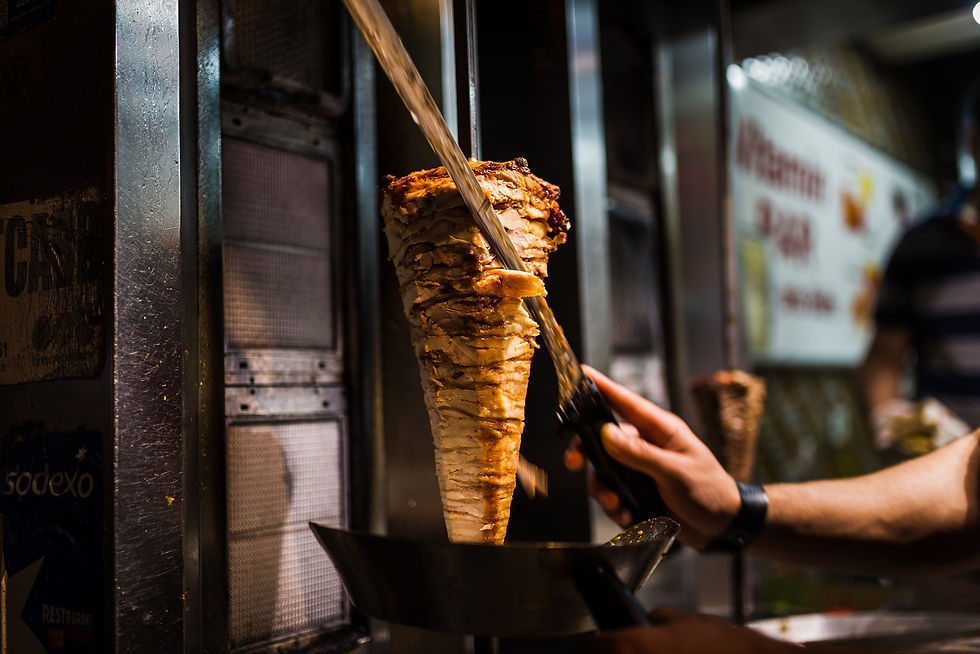 An arm moving to cut the kebab meat .jpg