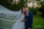 Eastwood Hall sunset weddings with bride kissing the grooms cheek