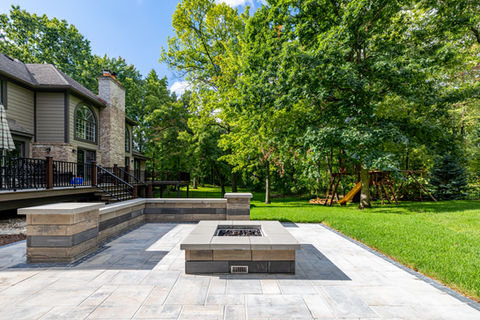 Backyard brick paver patio with seating wall in Okemos
