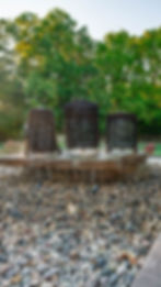 Custom backyard water feature installation featuring natural stone waterfall and decorative pond design.