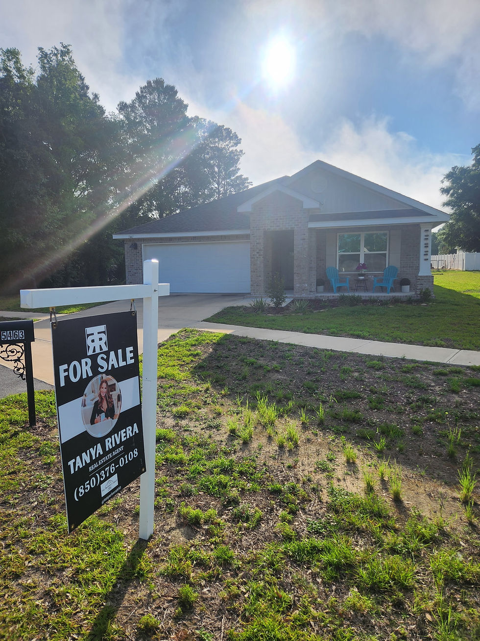 Tanya Rivera REALTOR For Sale sign in front of a brick home in Crestview, FL