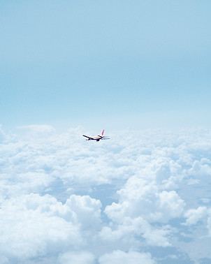 Airplane Above the Clouds