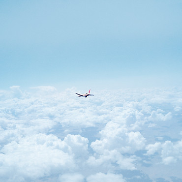 Airplane Above the Clouds