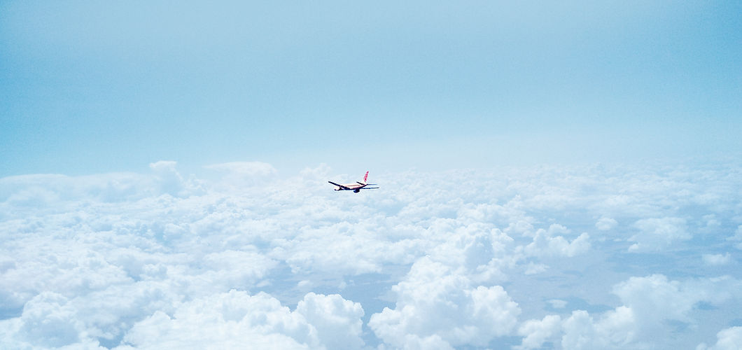 Airplane Above the Clouds