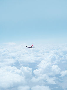 Airplane Above the Clouds